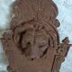 Old cast iron wall fountain with lion's head