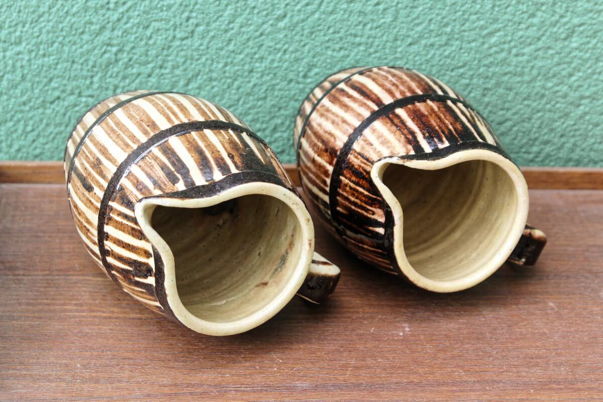 Pair of trompe l'oeil bistro pitchers, barrels