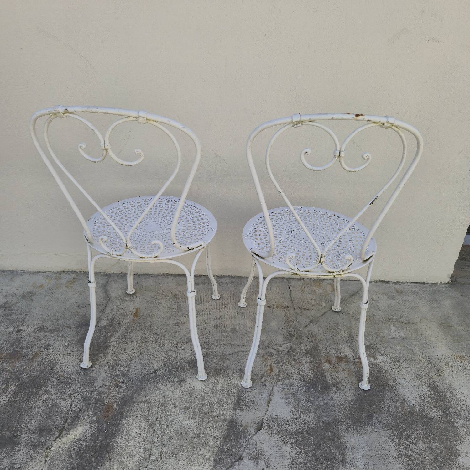Pair of wrought iron garden chairs, antique manufacture
