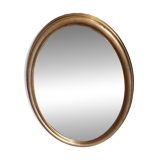Large and elegant oval gilded mirror with its beveled glass