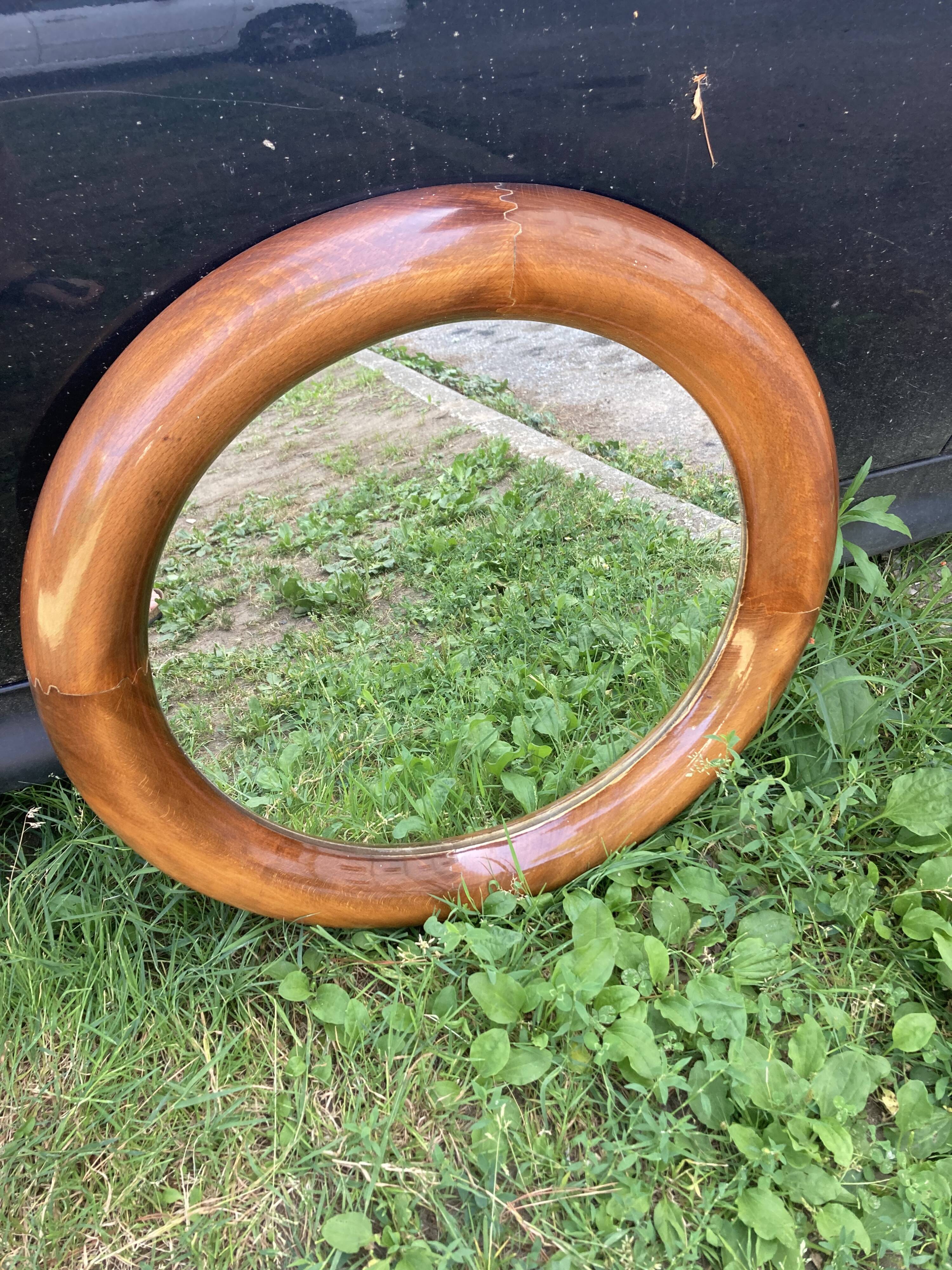 Round varnished wooden mirror