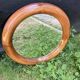 Round varnished wooden mirror