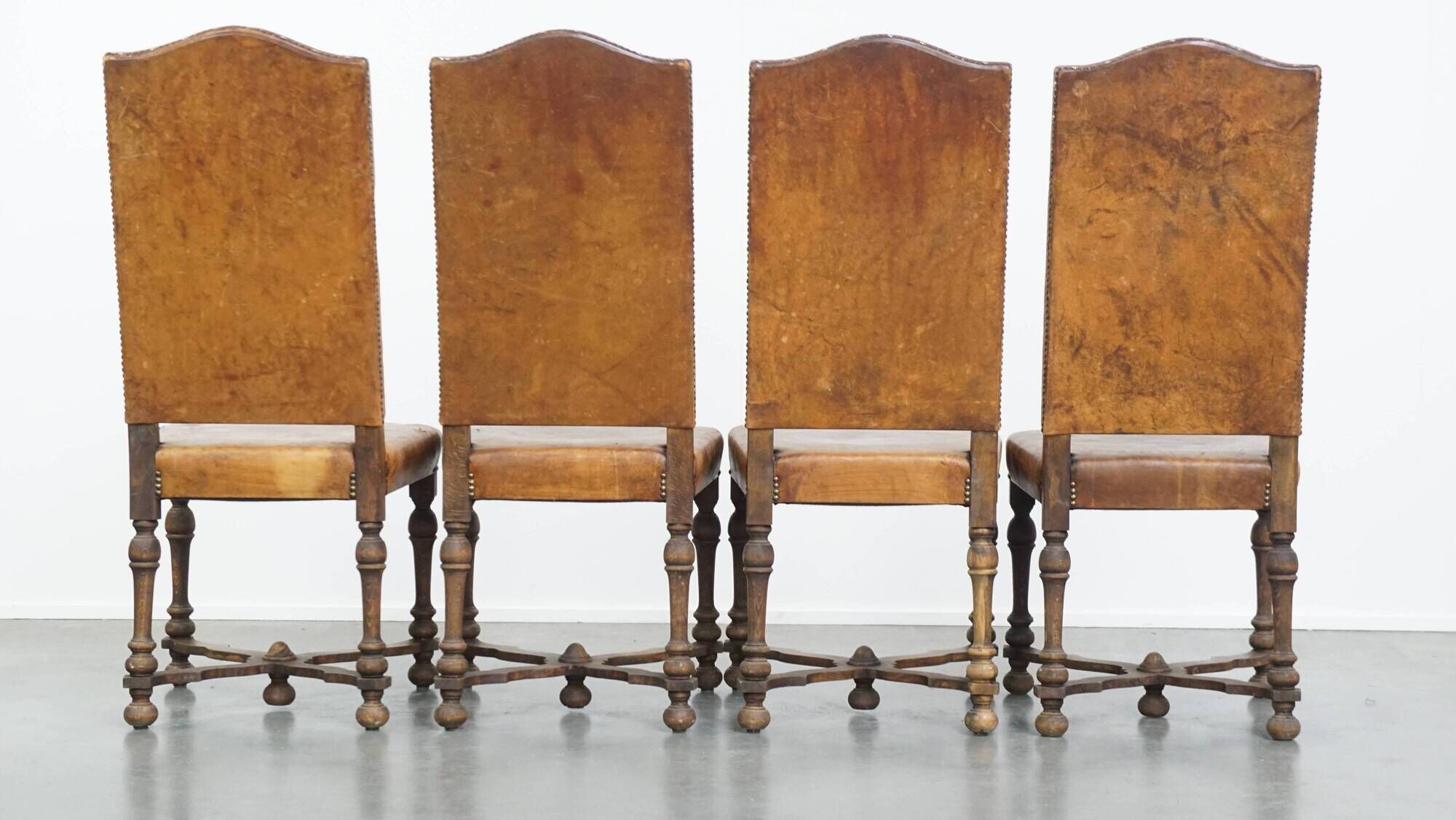 Set of 4 antique wooden and sheepskin leather dining chairs