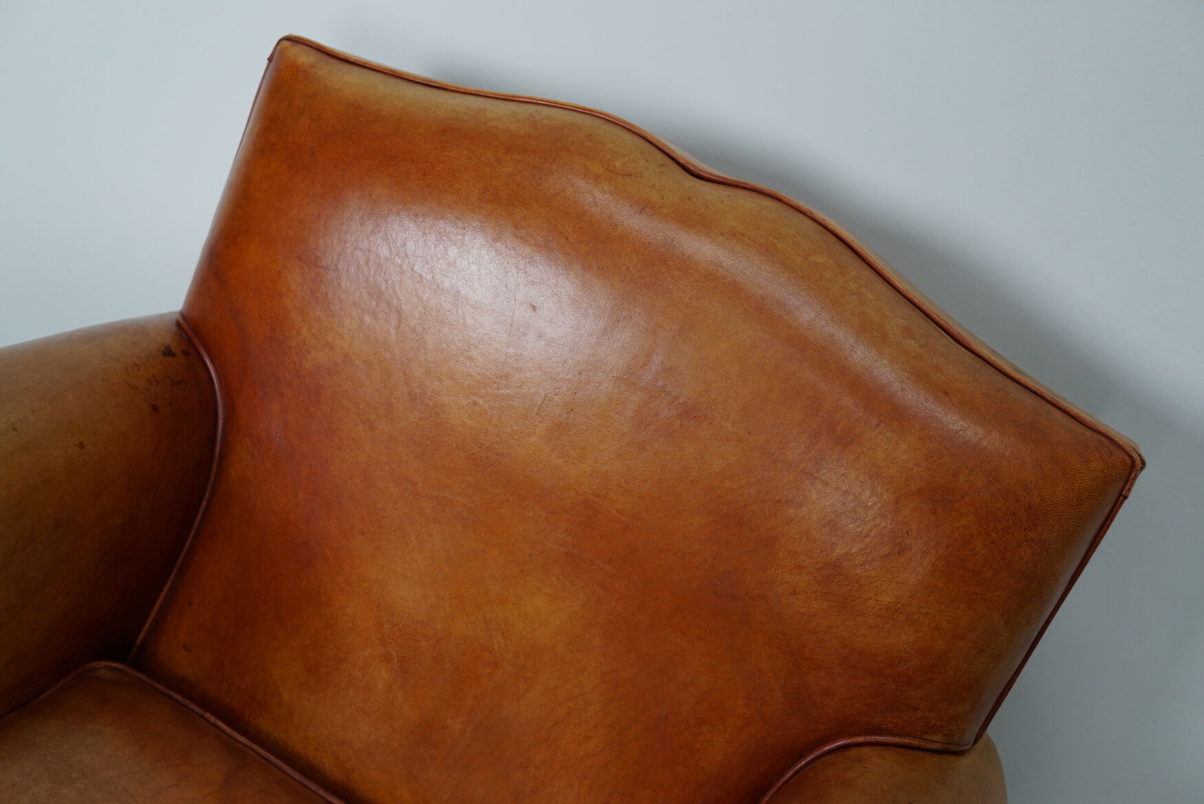 Vintage french moustache back cognac-colored leather club chair