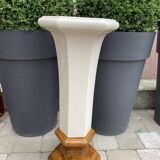 Column wears vintage plant