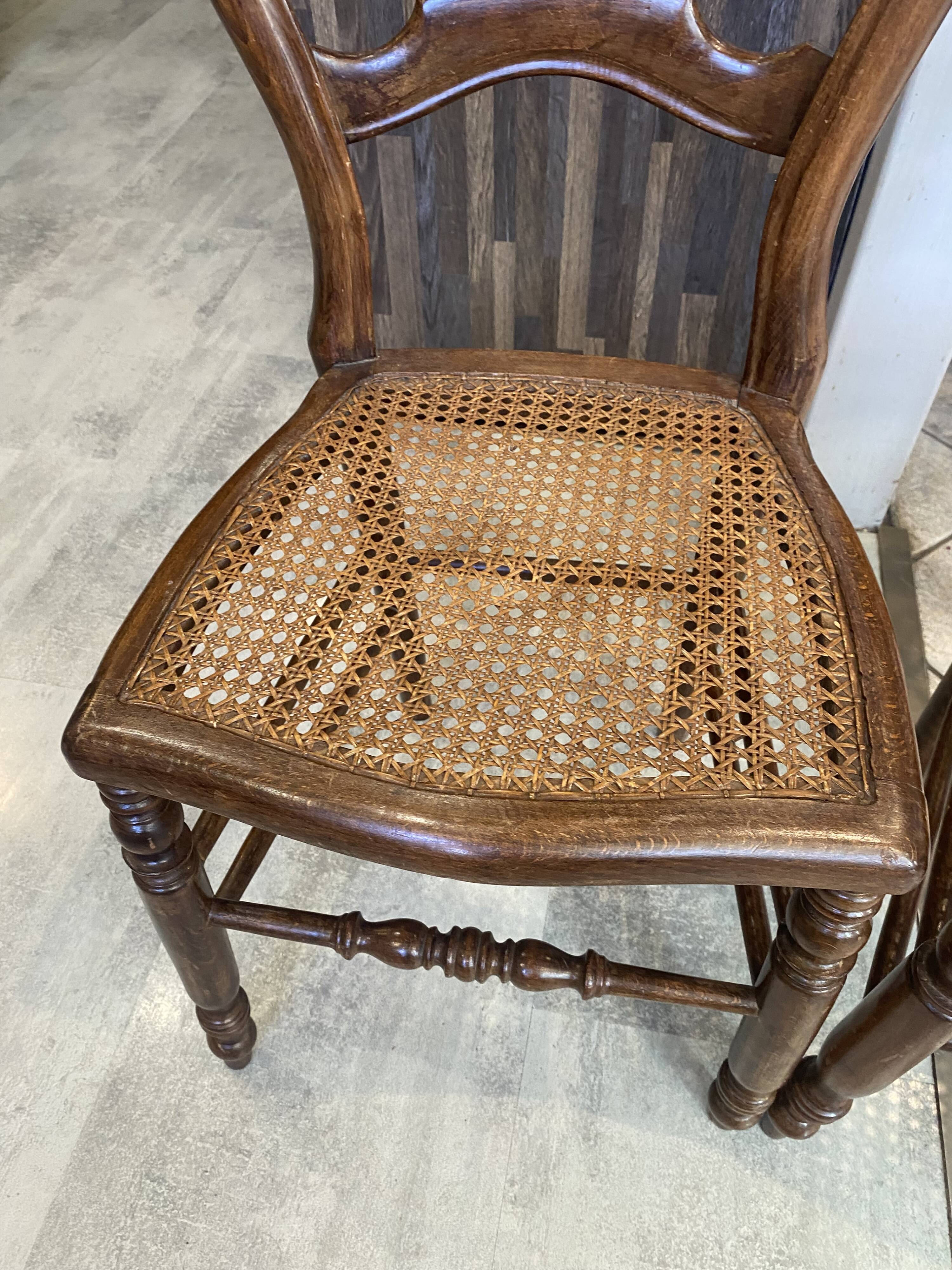 Pair of N2 antique caned and wooden chairs from the 1900s.