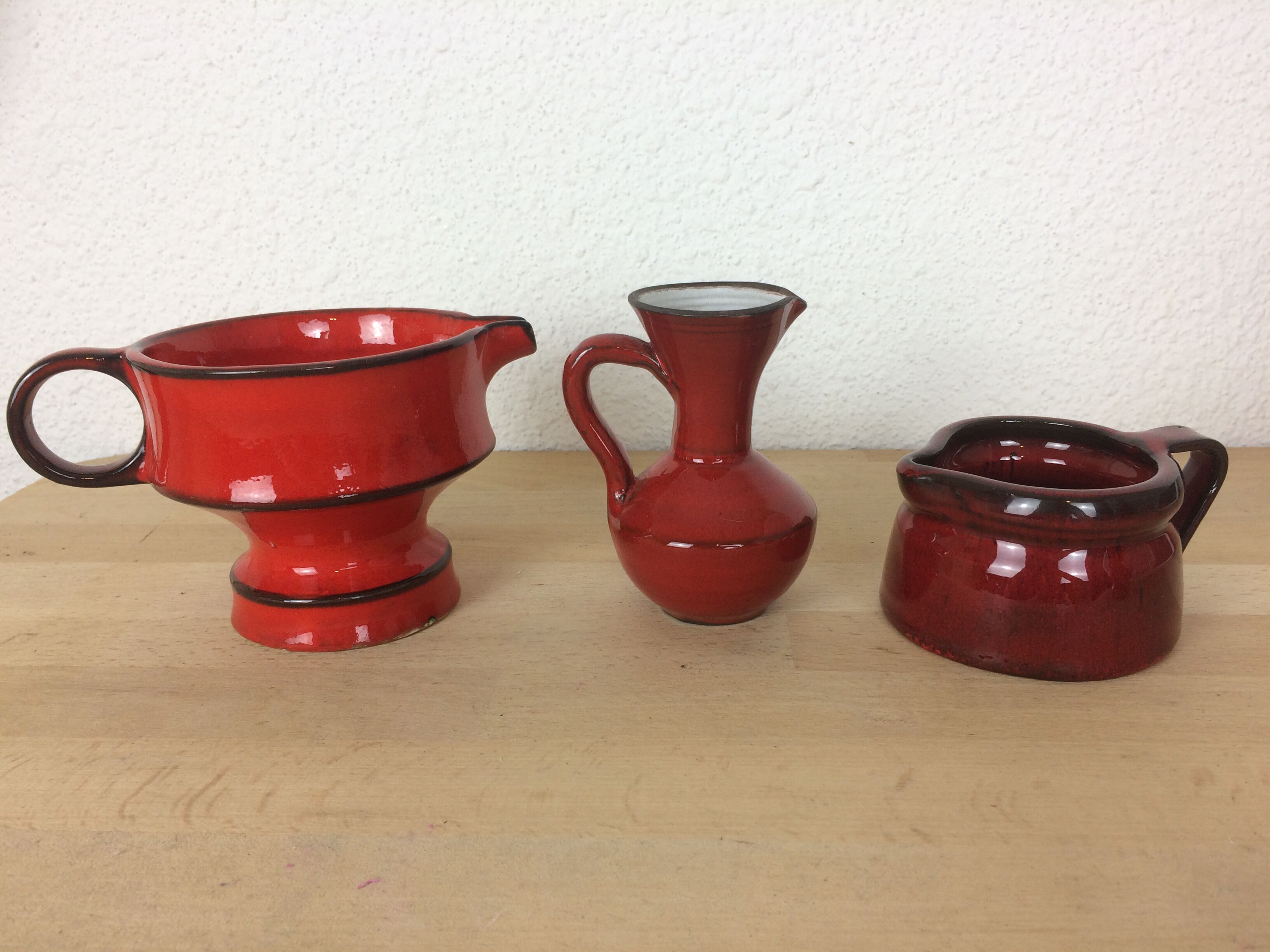 3 red ceramic vases