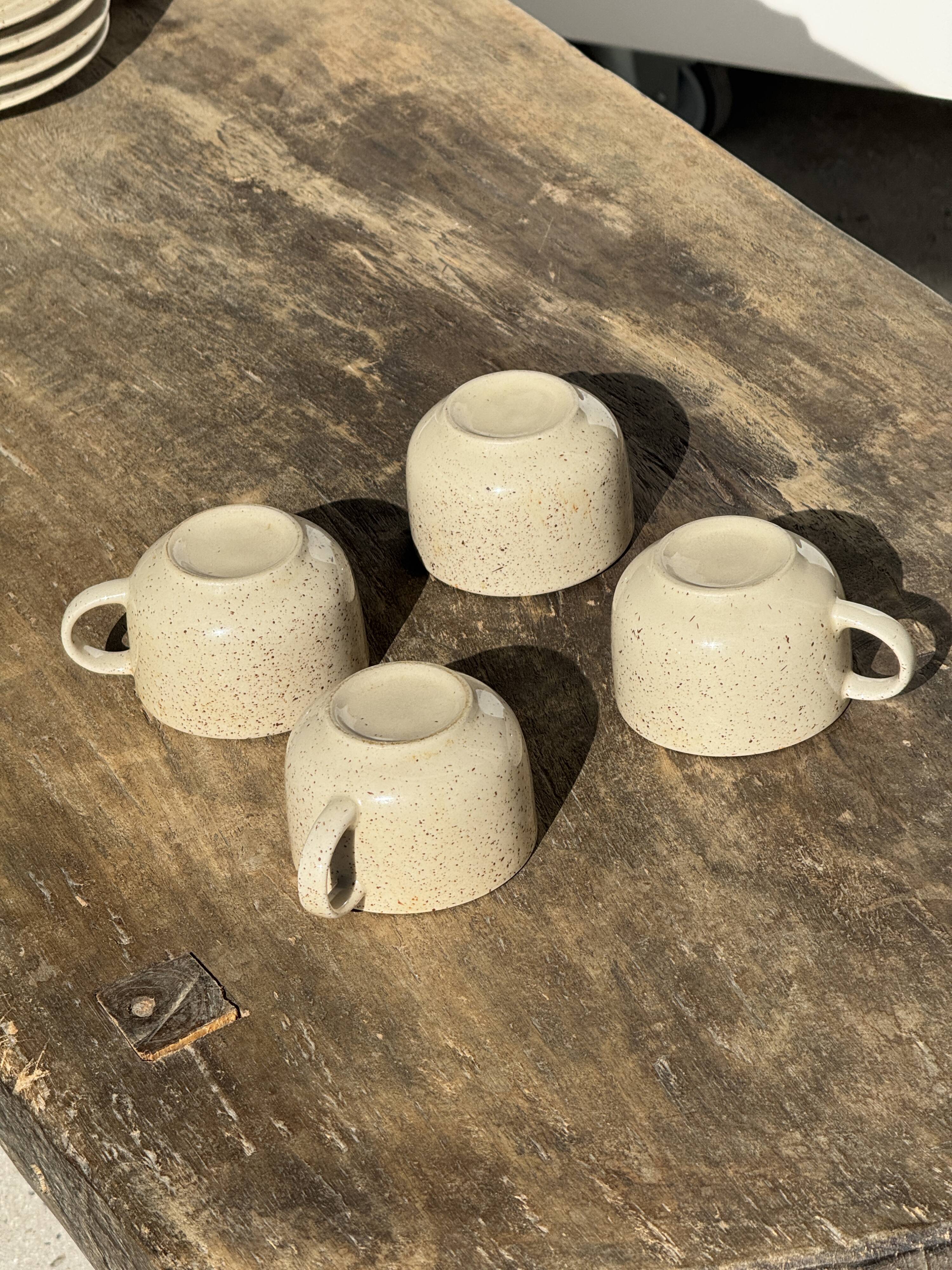 Set of 4 vintage speckled beige stoneware coffee cups.
