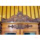 Antique carved wooden sideboard with several sculptures.