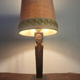 Old lamp with carved wooden base representing a wise man