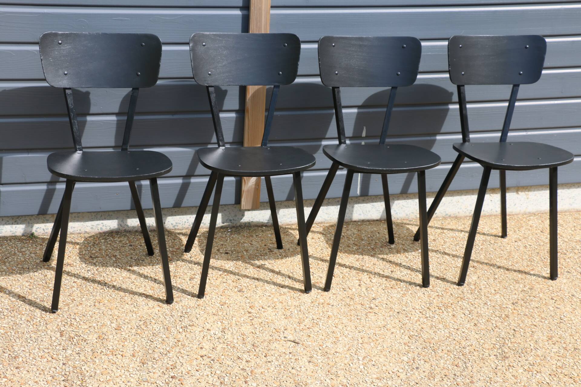 4 black metal and wood chairs