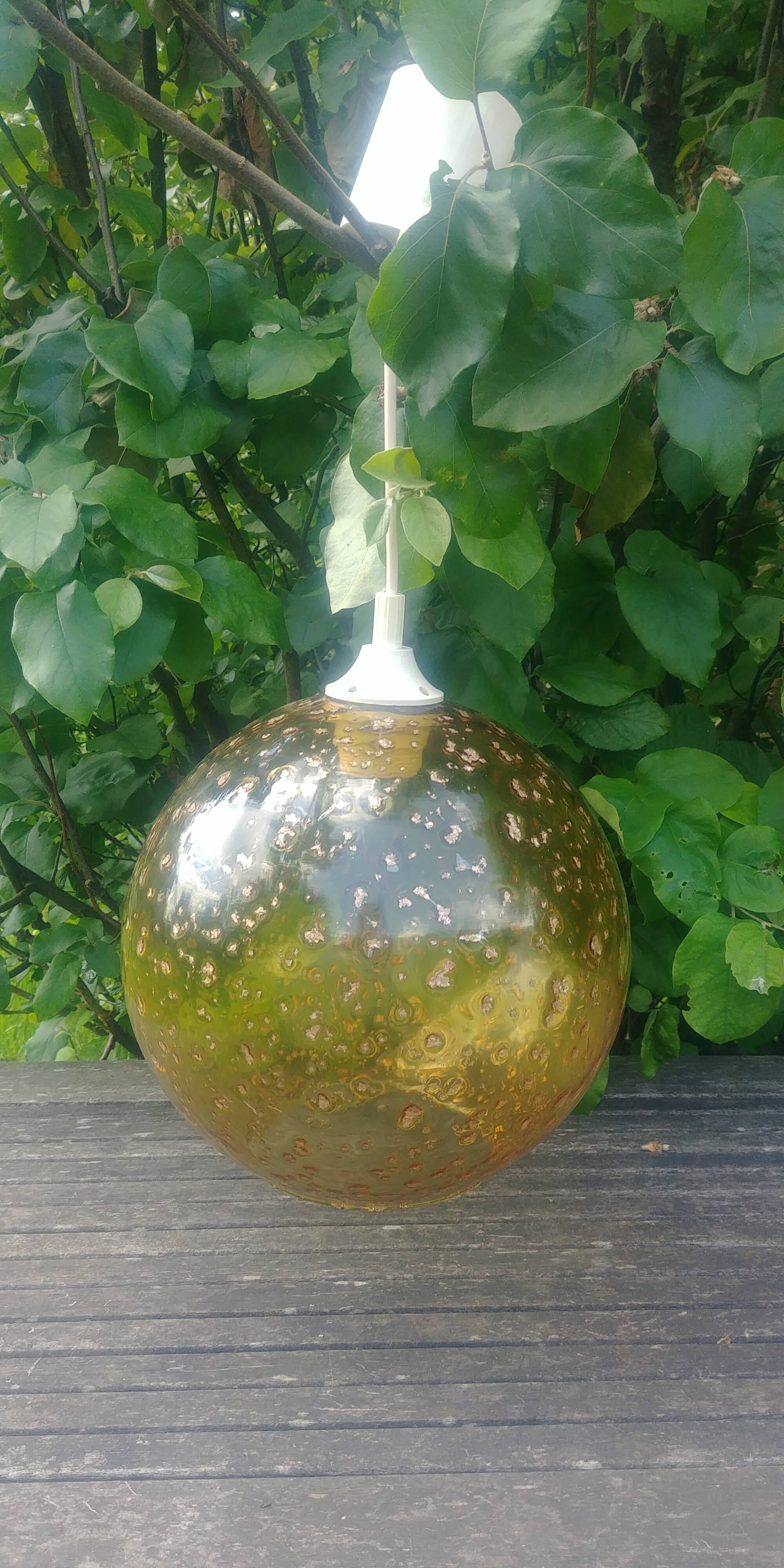 A vintage 70s blown glass pendant light with gold glitter in a globe shape