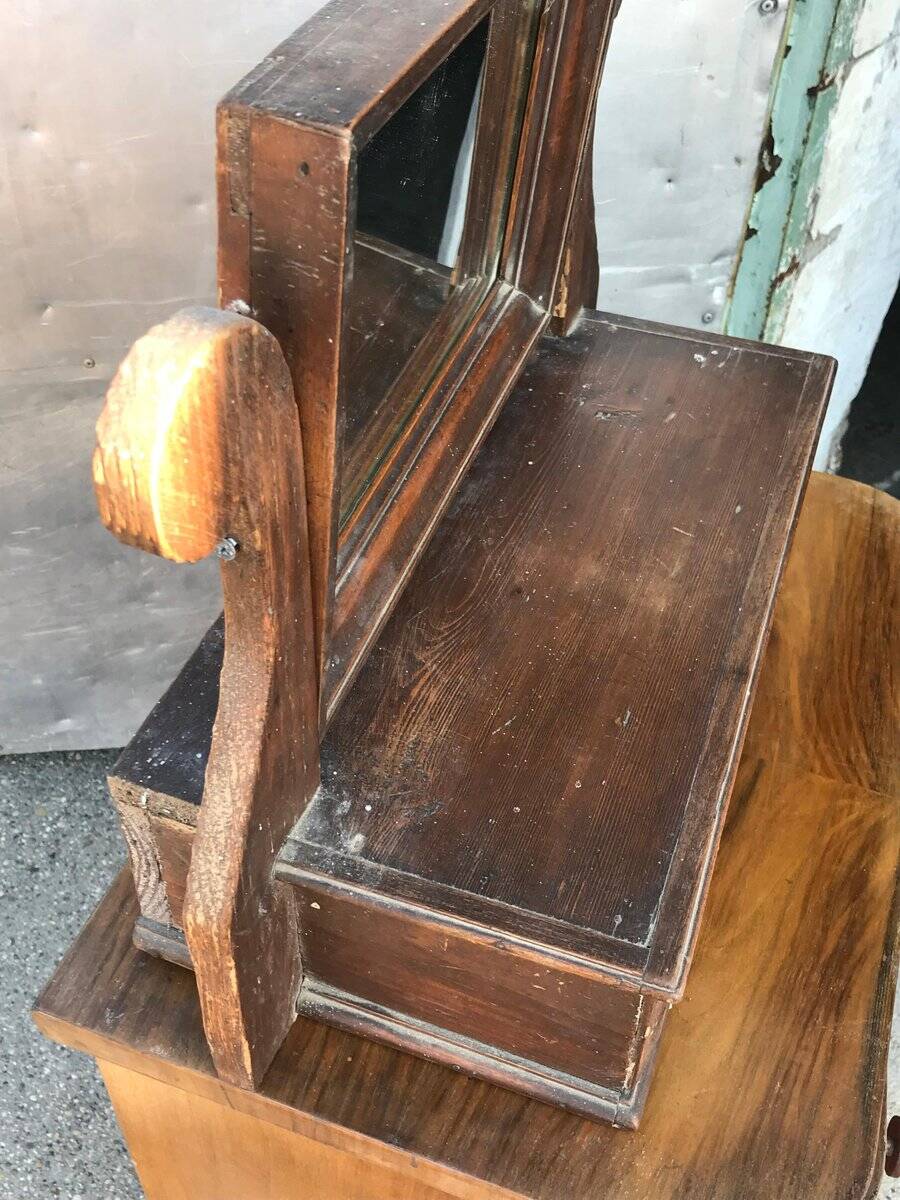 Rustic brown pine mirror, 1920s German style with decorative drawer casing.