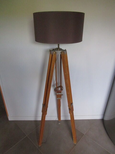 Old floor lamp on surveyor tripod