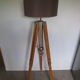 Old floor lamp on surveyor tripod