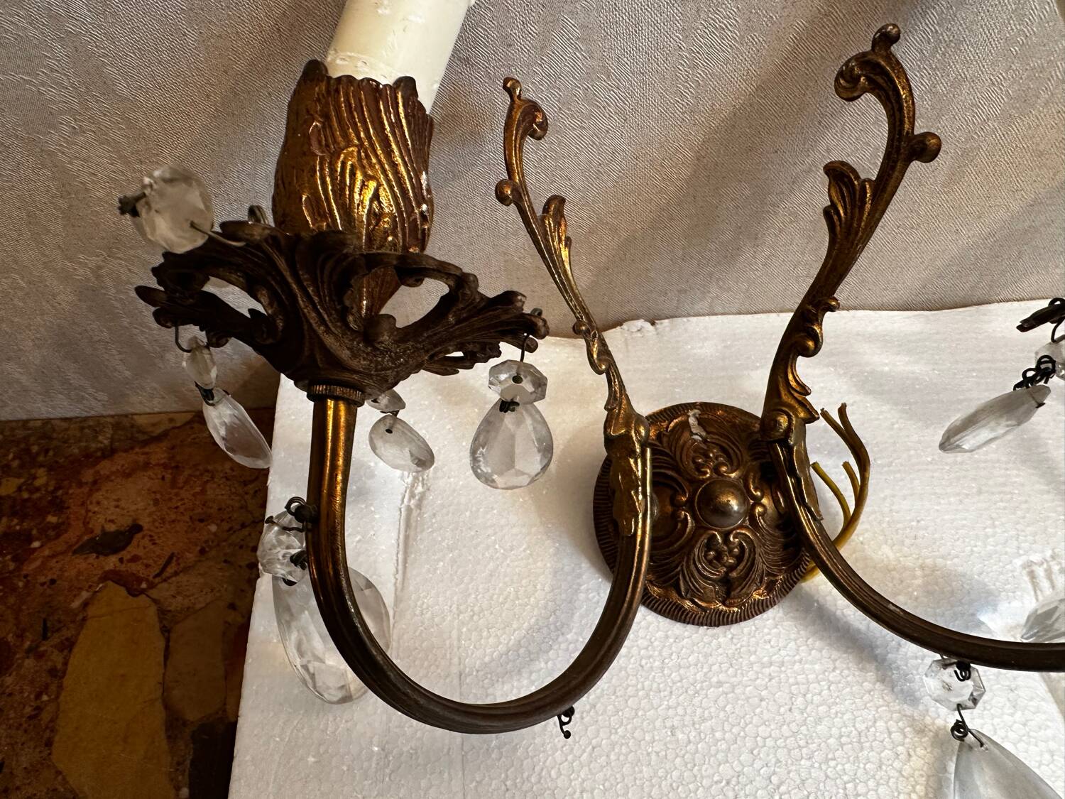 Pair of Louis XV style wall sconces in gilded bronze with glass pendants.