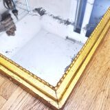 Old mercury mirror in carved wood, gilded with leaf.
