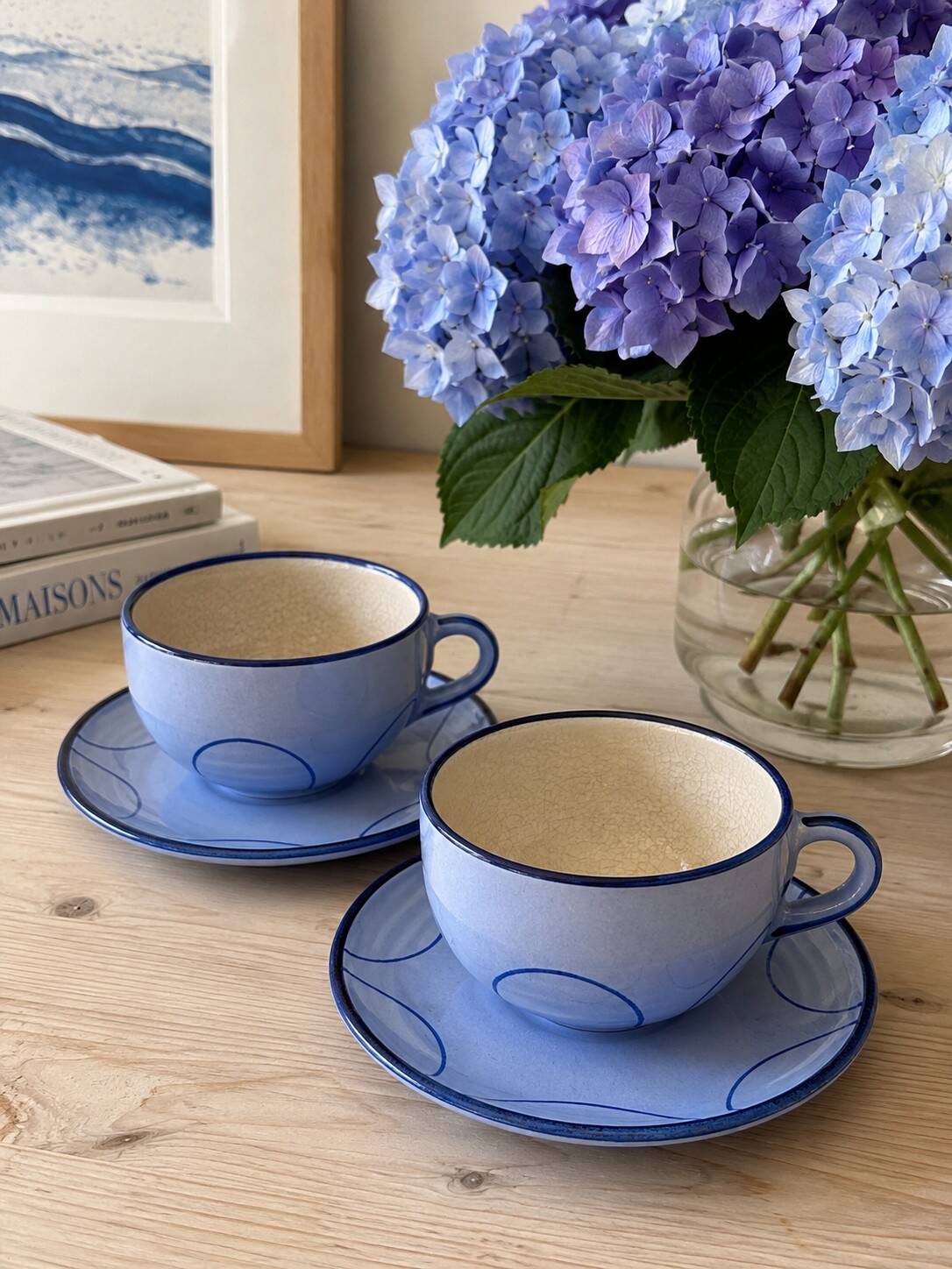 A pair of glazed ceramic cups and saucers from the 60s-70s.