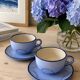 A pair of glazed ceramic cups and saucers from the 60s-70s.
