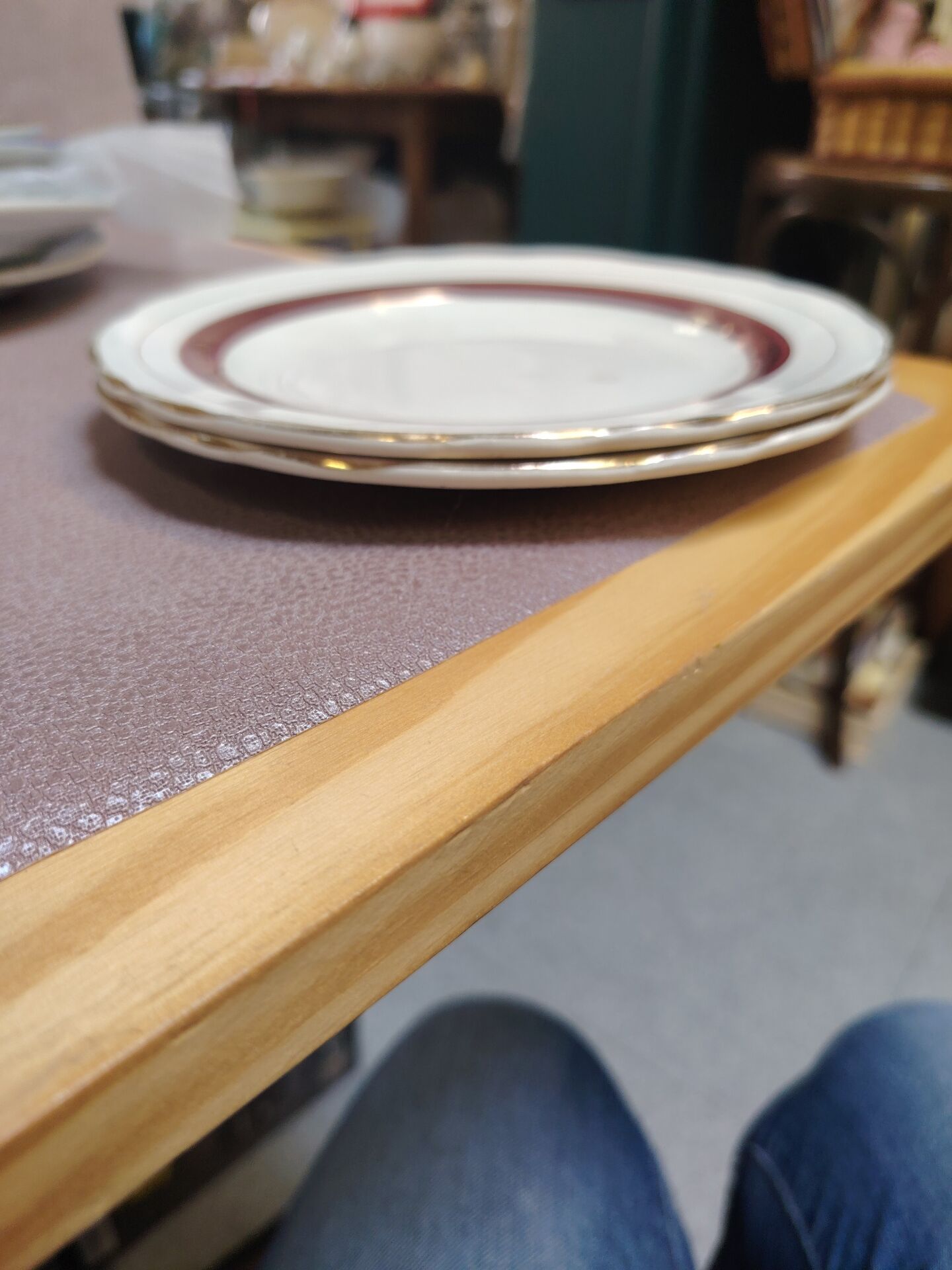 Salins white ceramic dessert plates with red trim and gold rim.