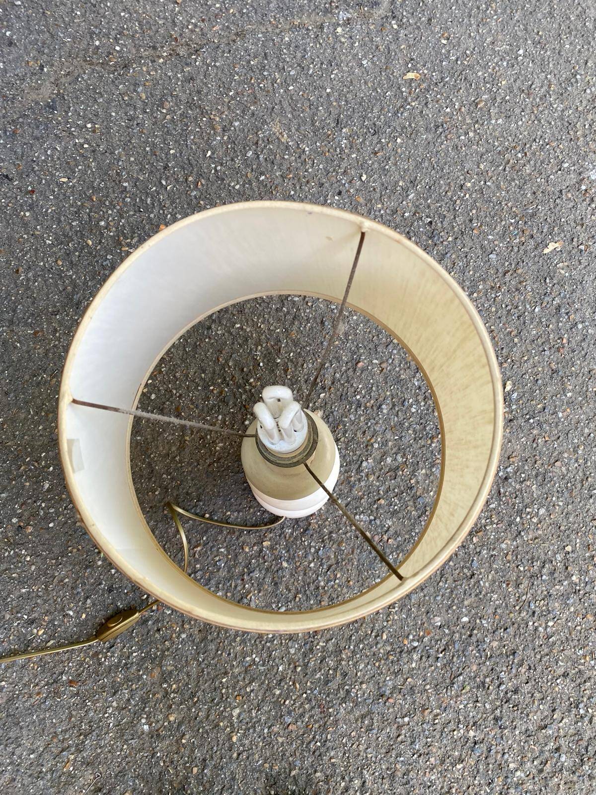 Space age bedside lamp in off-white wood with a metal band.