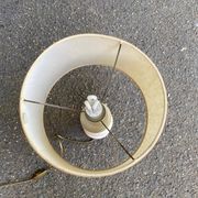 Space age bedside lamp in off-white wood with a metal band.
