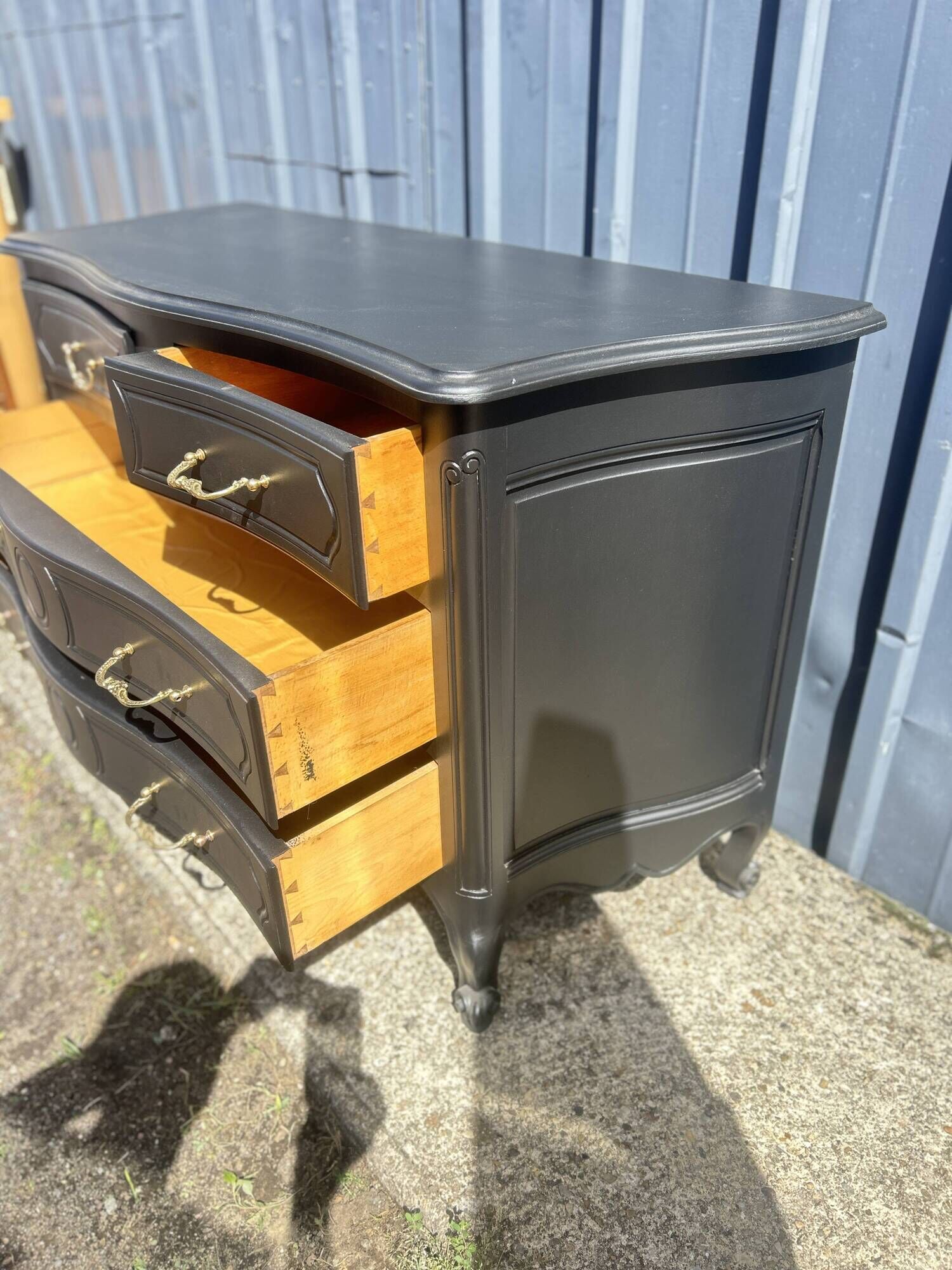 Louis XV style black lacquered chest of drawers with four drawers.