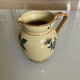 Old ceramic jug with floral decoration