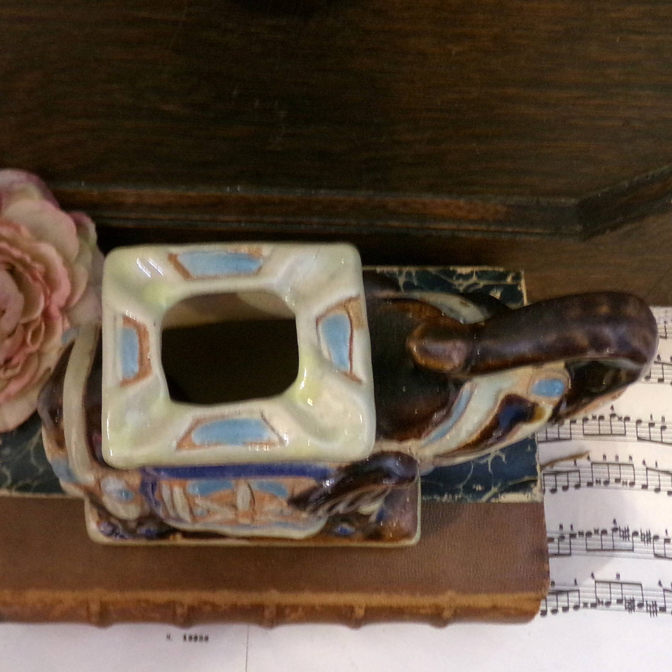 Small brown ceramic elephant vase