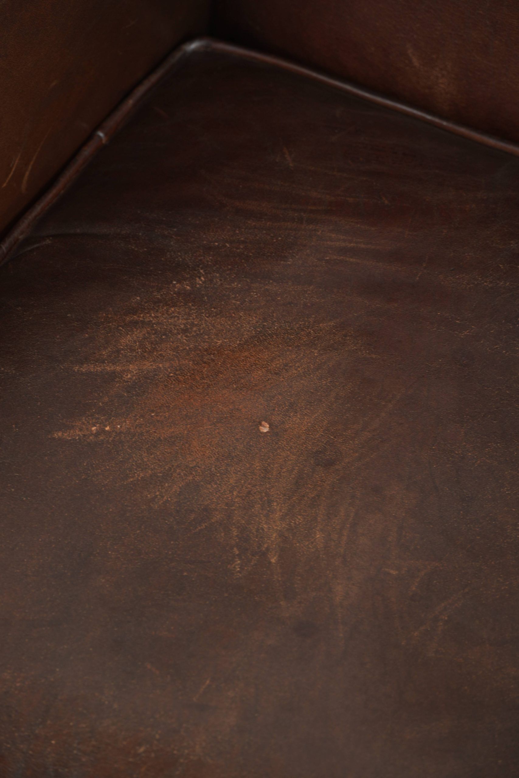 Subtle sheepskin wingback armchair with a deep cognac colour