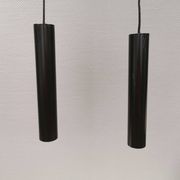 Two cylinder-shaped hanging lamps in black lacquer