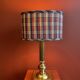 Lamp base in gilded brass, oval silk lampshade with a checkered pattern in burgundy.