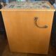New oak storage furniture with a signed artisanal mosaic top.