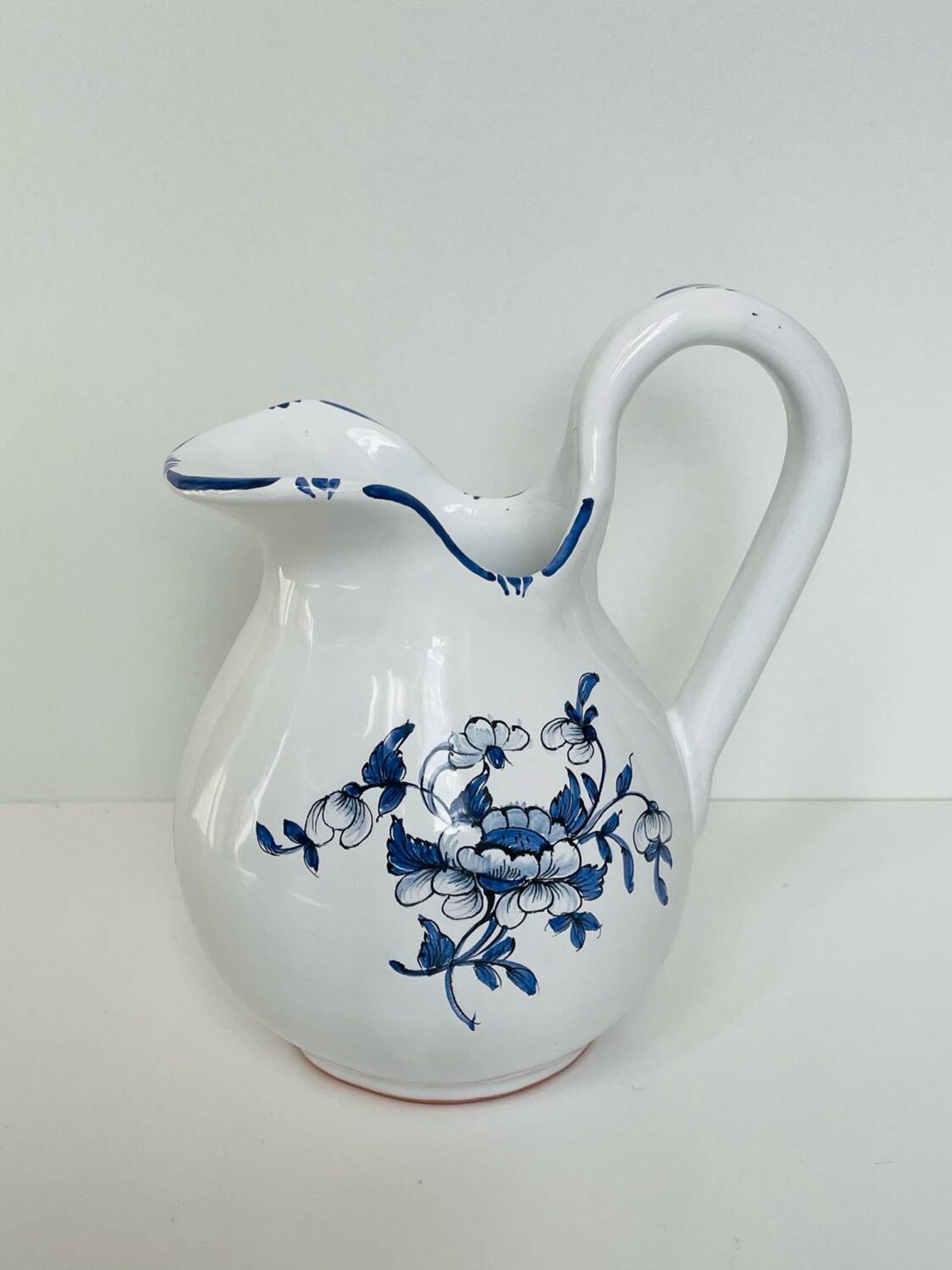 Moustiers pitcher with blue floral decoration