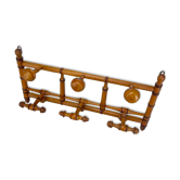 Old coat rack in frame with fixed and mobile hooks