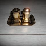 Silver-plated salt and pepper shakers presented on a small tray