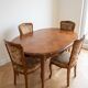Oval table and 4 chairs in Louis XV style made of wood.
