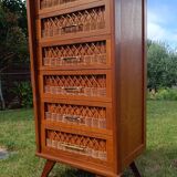 Tall chest of drawers in wood and rattan with splayed legs