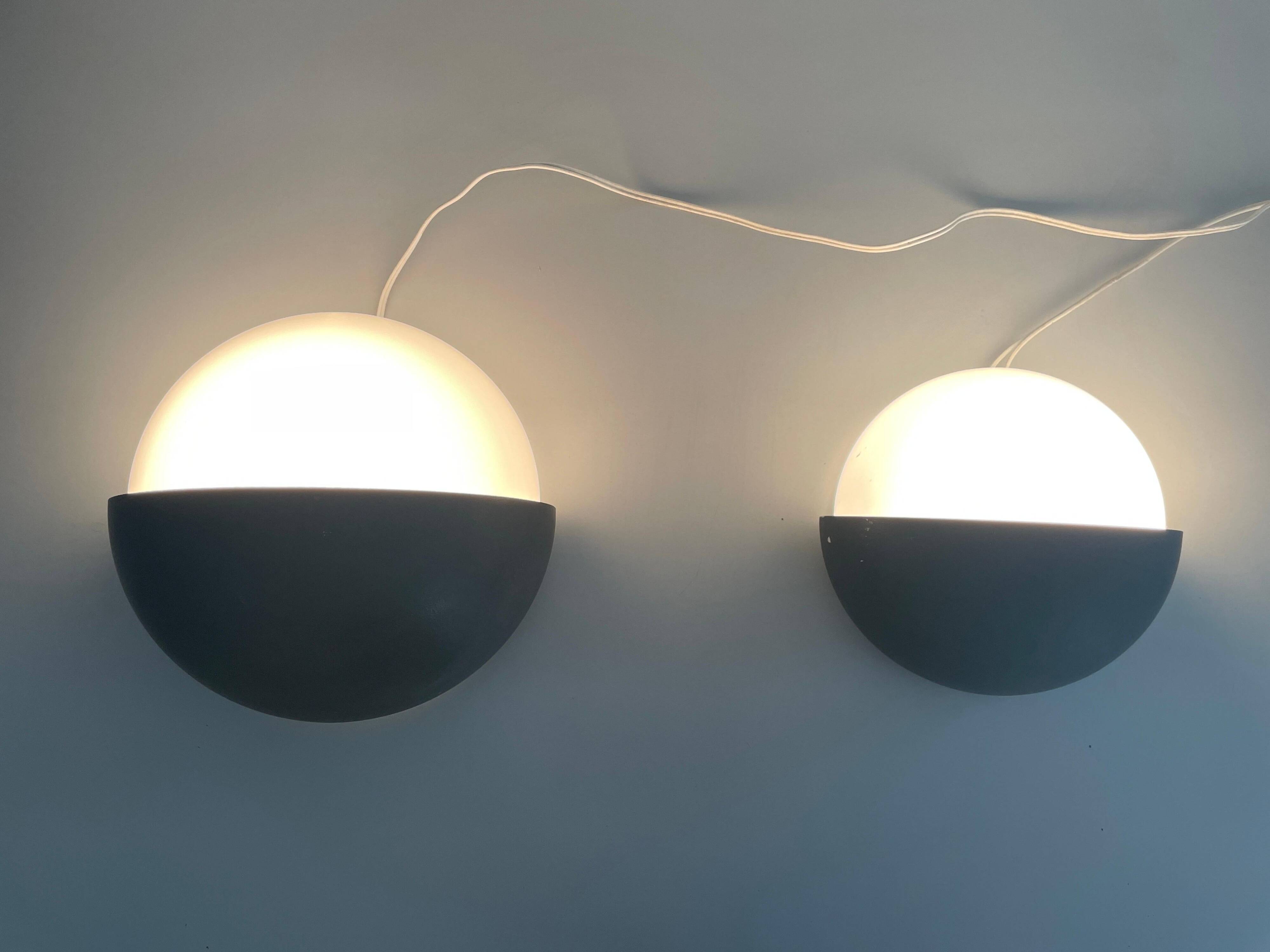 Round black metal wall lights, small and large set, by Bega, 1970s, Germany.