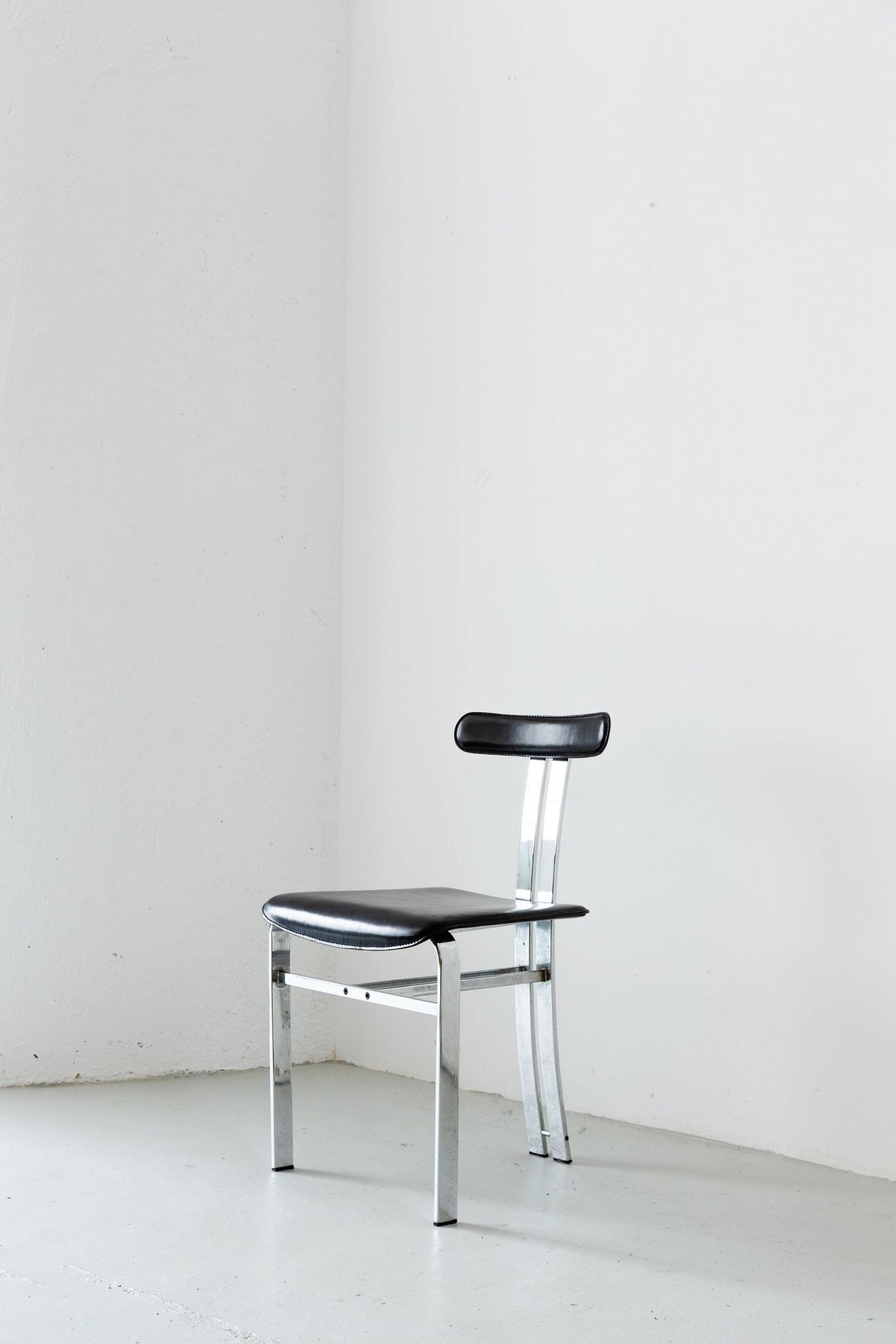 Pair of vintage Italian made dining chairs in chromed metal and black leather