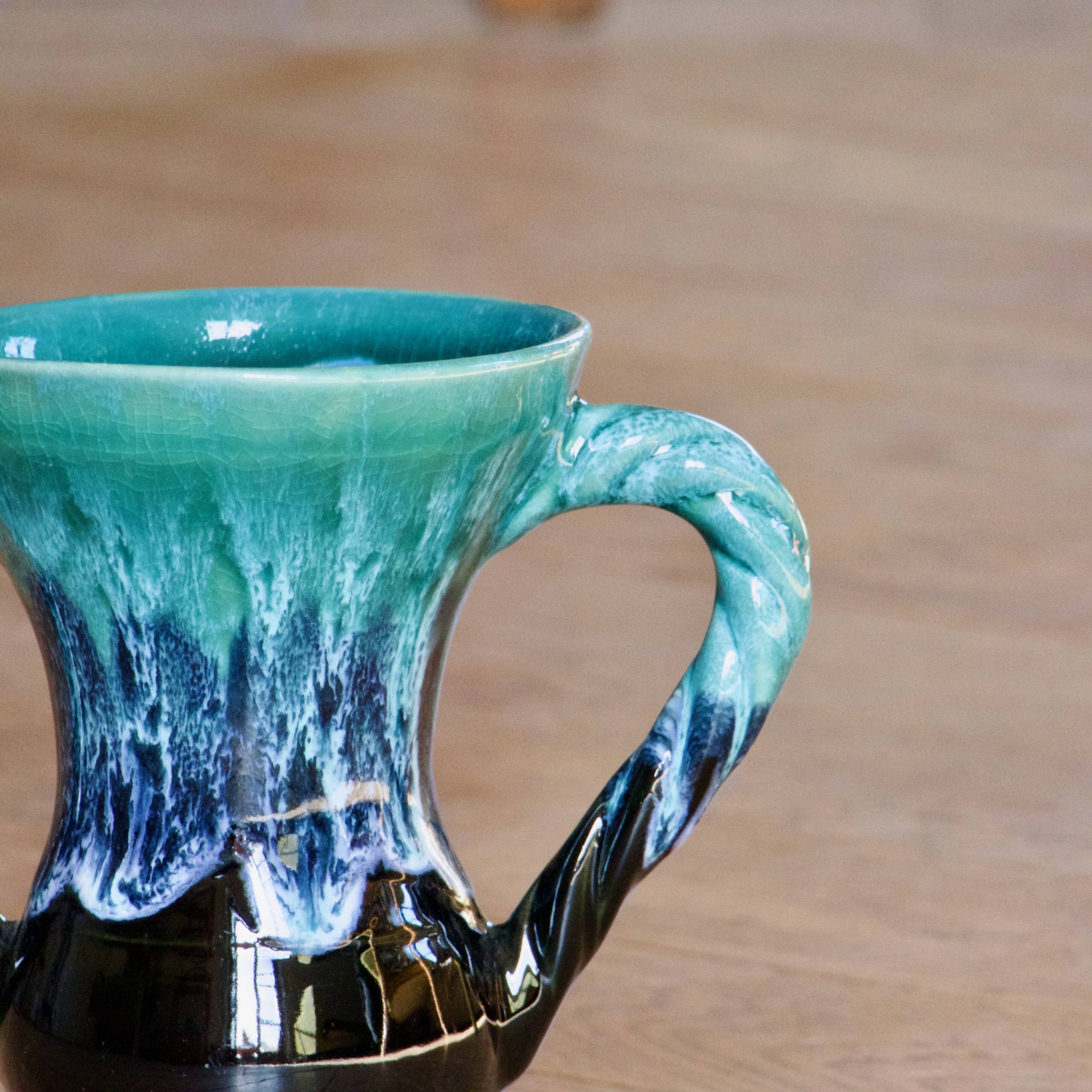 Ancient amphora vase in turquoise glazed stoneware.