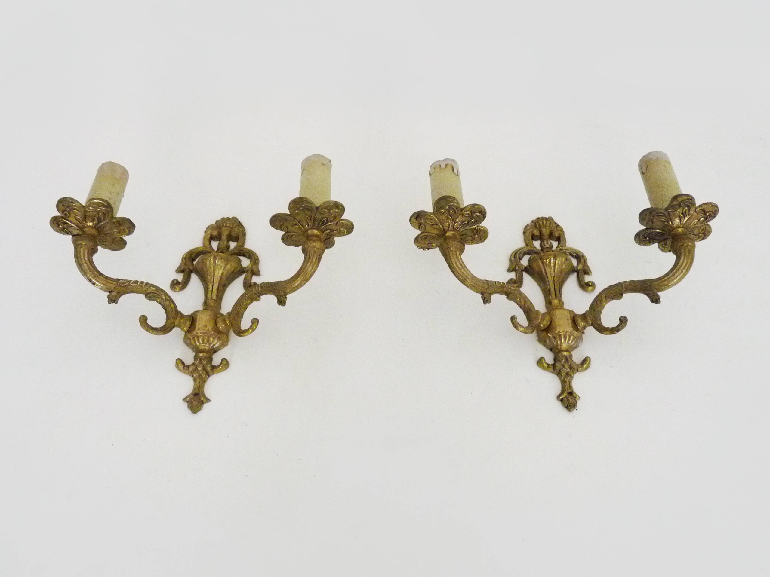 Pair of two-armed fire pot wall lights in gilded bronze.