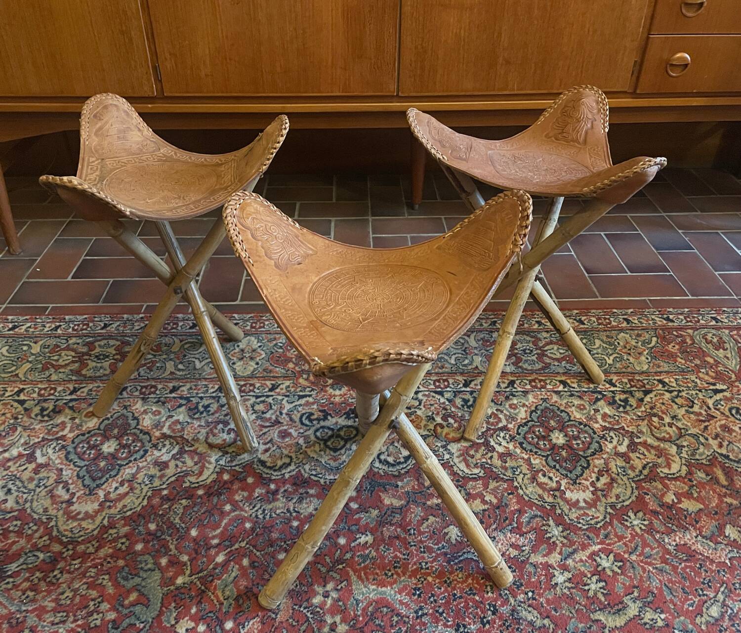 Vintage Mexican tripod stools in bamboo and leather.