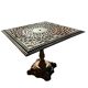 Antique cast iron garden table with decorative openwork top.