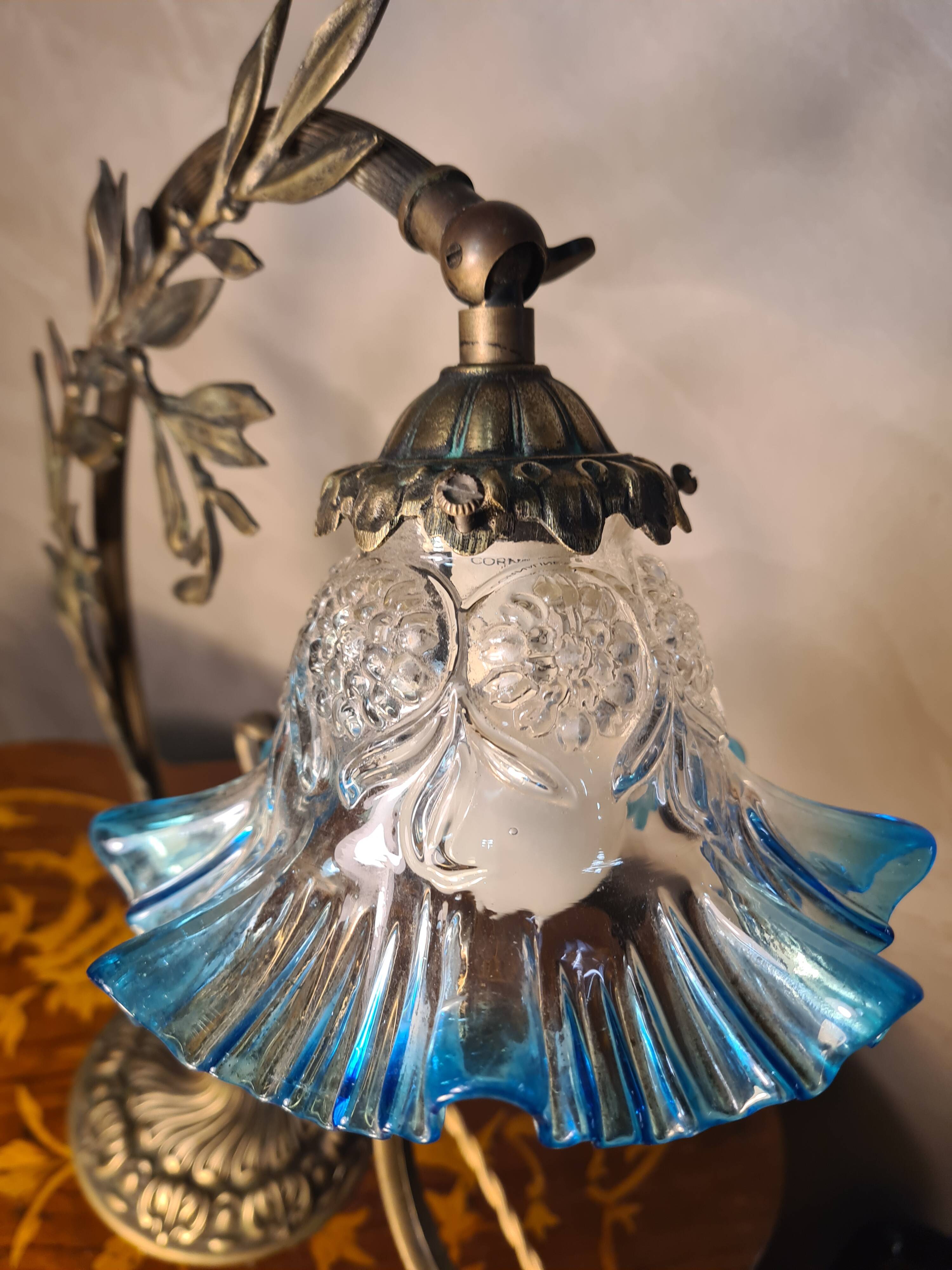 Bronze and brass lamp, transparent and blue glass shade.