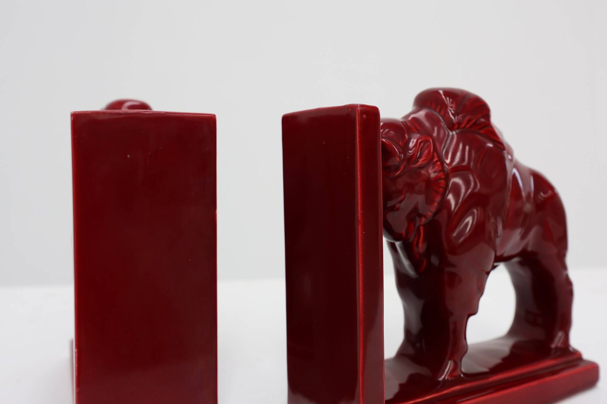 Pair of red glazed ceramic Bison ox bookends in Art Deco style, Belgium