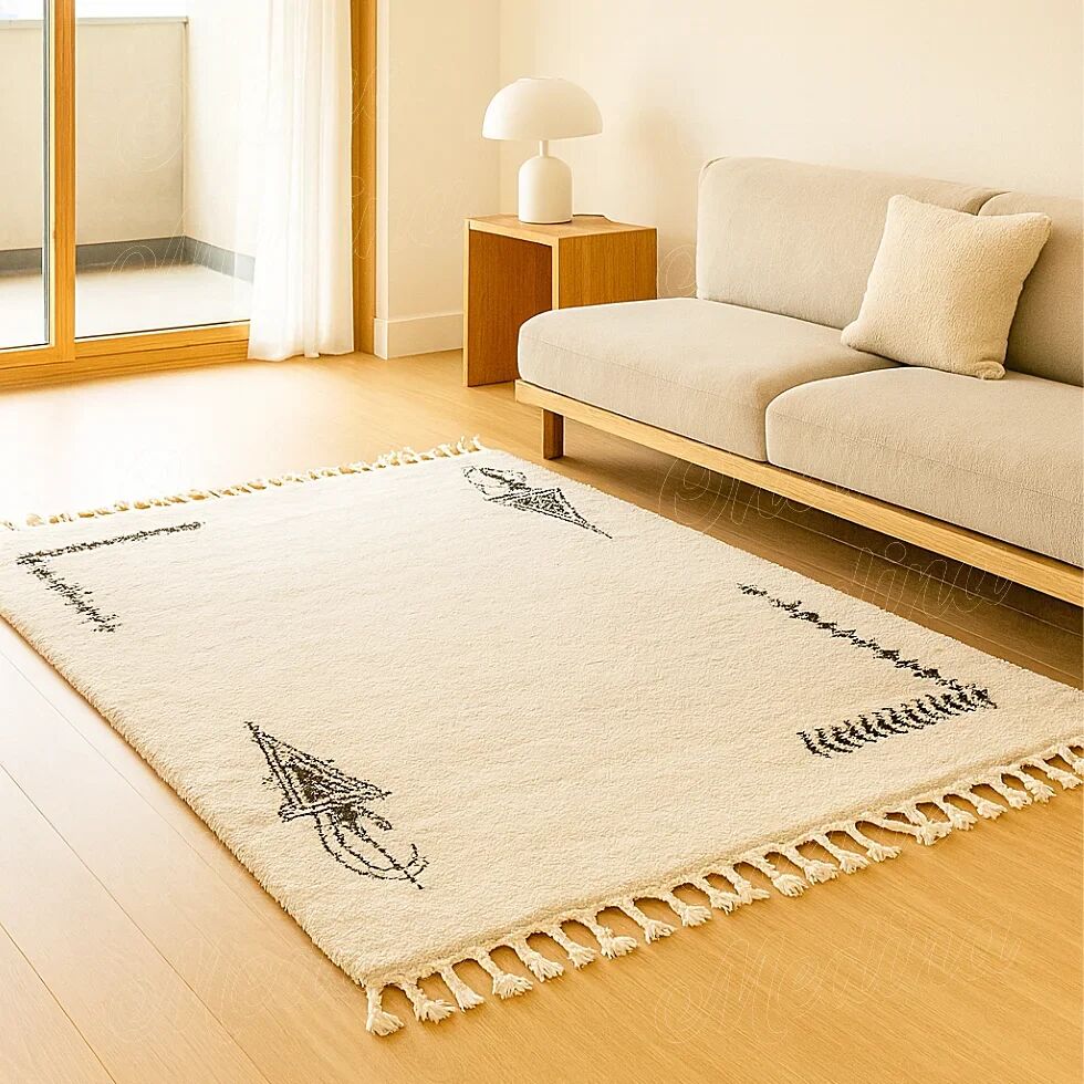 Ecru Berber rug with symbolic corner patterns.