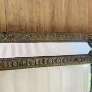 Small mirror with repoussé brass frame.