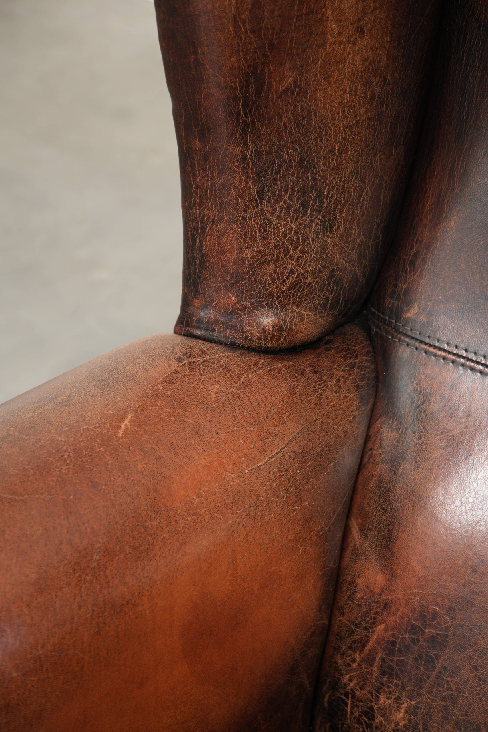 Vintage sheepskin wingback armchair in a deep brown colour finished