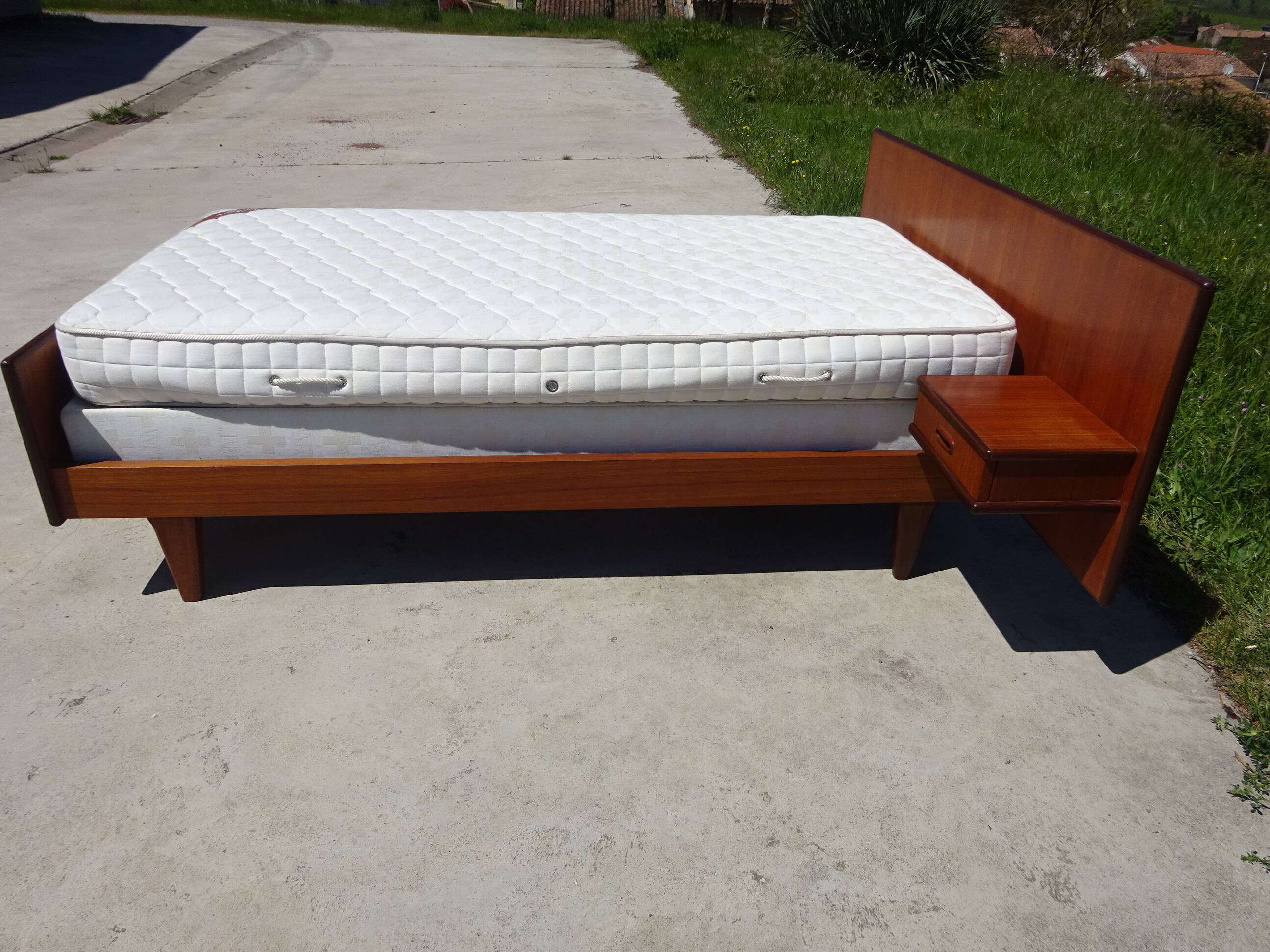 Vintage bed in teak with integrated bedside table.